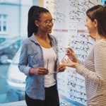 African,American,Woman,In,An,Optometrist,Store,Being,Assisted,In