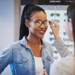 Optometrist,Fitting,Glasses,On,An,Attractive,African,American,Woman,Customer