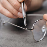Closeup,Of,Optician's,Hands,Repairing,Glasses,With,Special,Tools,And