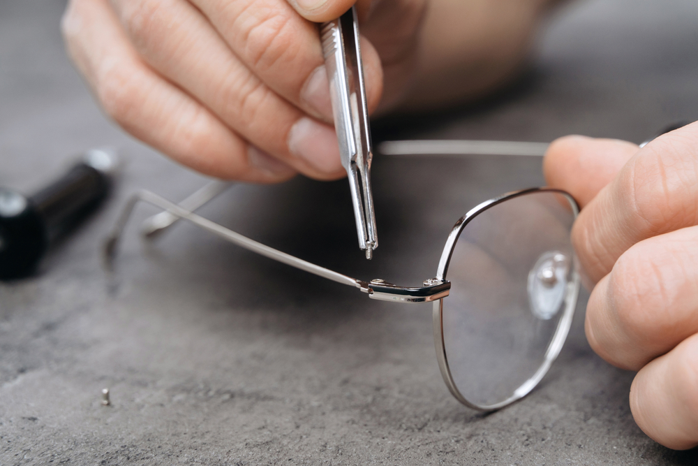Closeup,Of,Optician's,Hands,Repairing,Glasses,With,Special,Tools,And