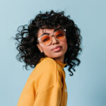 Dreamy,Young,Woman,In,Sunglasses,Looking,At,Camera.,Front,View