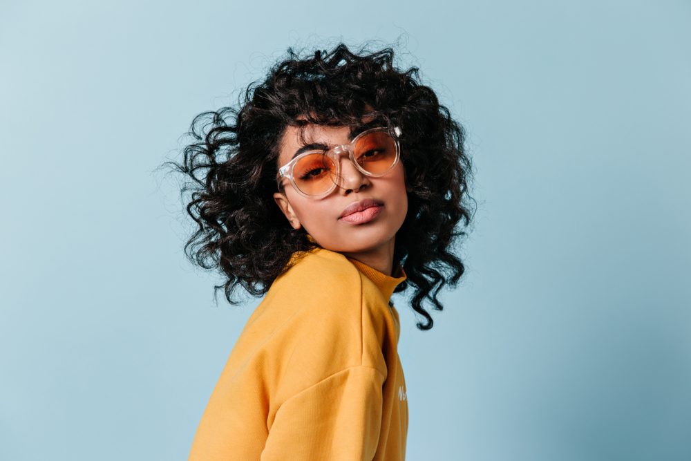 Dreamy,Young,Woman,In,Sunglasses,Looking,At,Camera.,Front,View