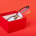Eye,Glasses,In,Red,Gift,Box,On,Red,Background,Copy