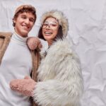 Joyful,Interracial,Couple,In,Fashionable,Warm,Outwear,On,White,Textured
